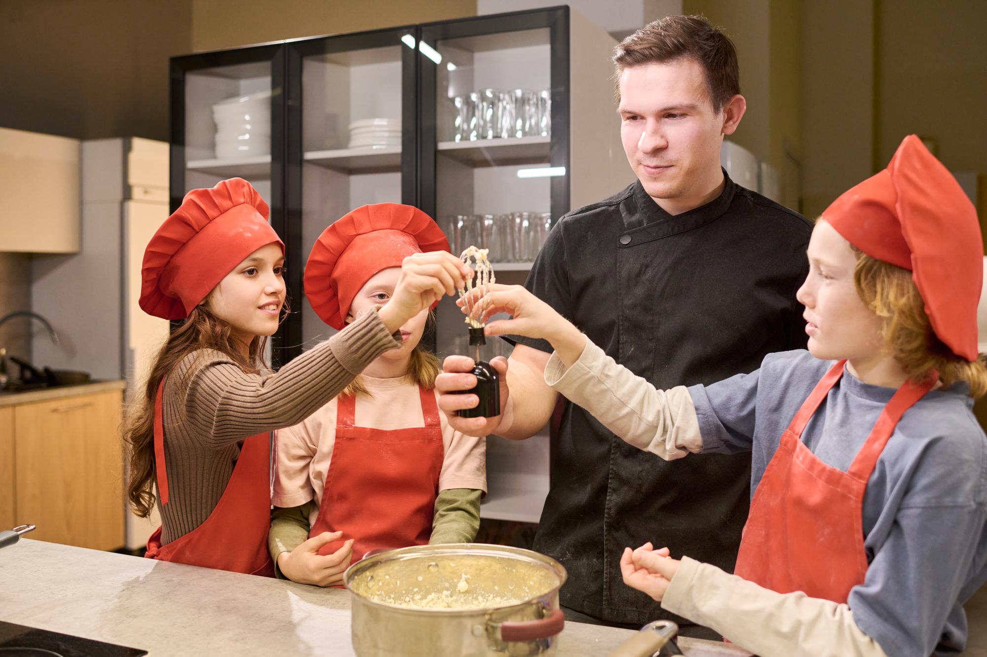 Instructor demonstrating sauce technique to students