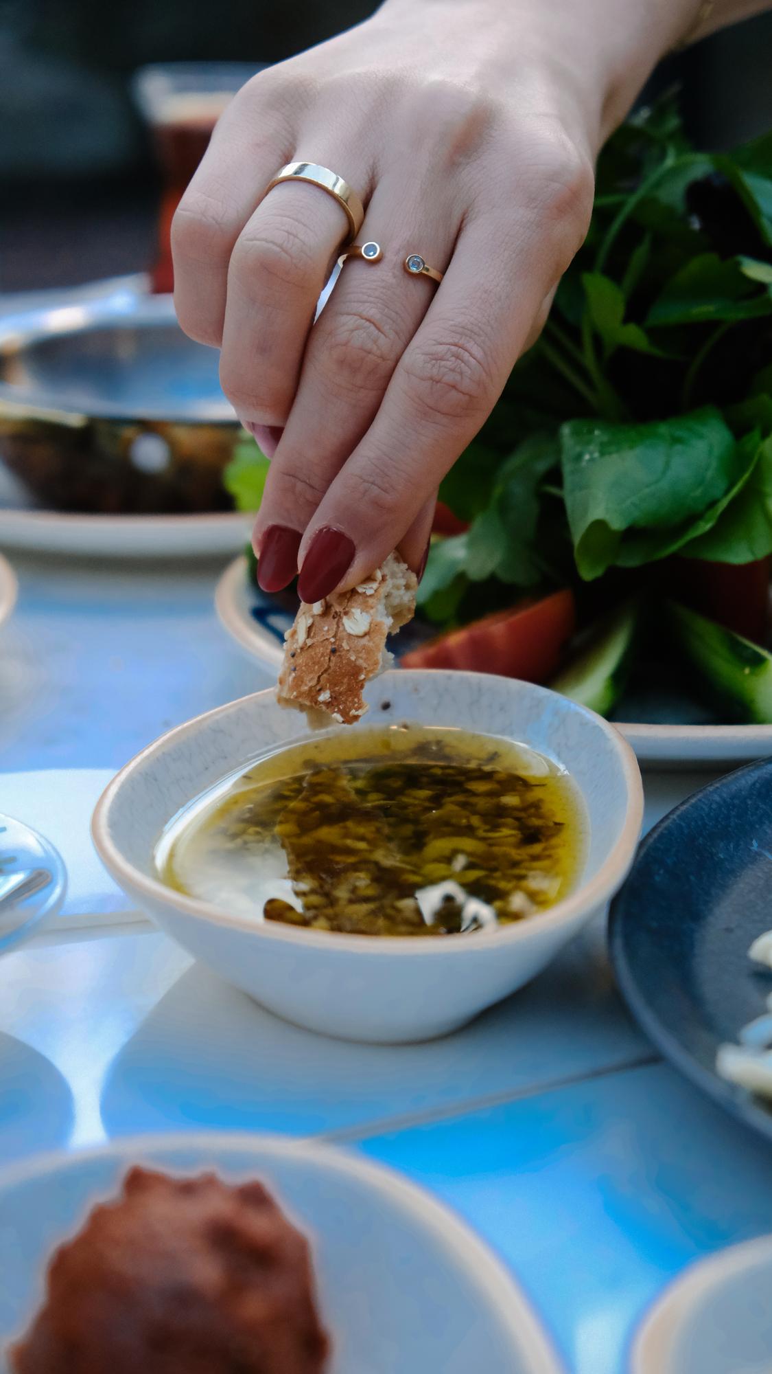 Close-up: hand seasoning a sauce