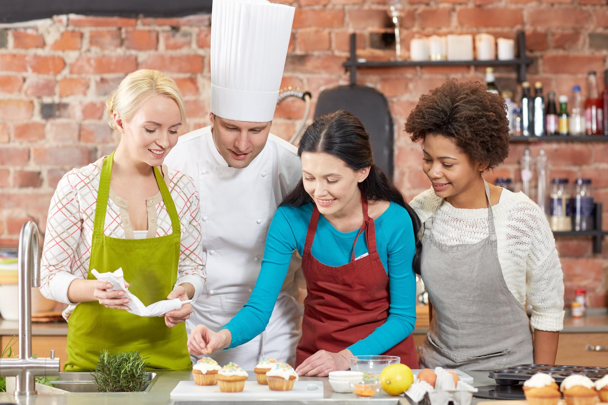 Students around a bench learning pastry technique